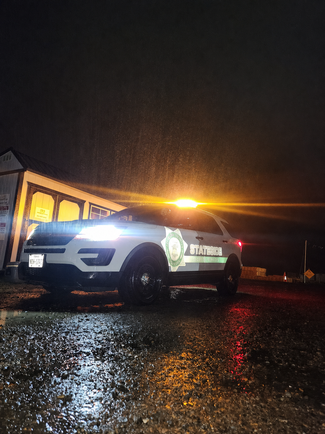 Stateside Security patrol vehicle in the rain at night